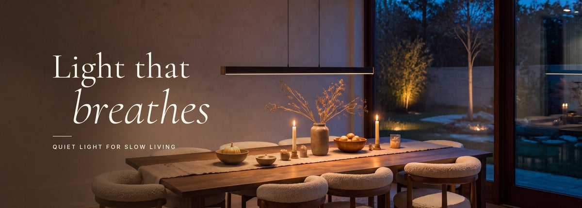 Light that breathes — the Noki linear pendant glowing over a dining table at dusk